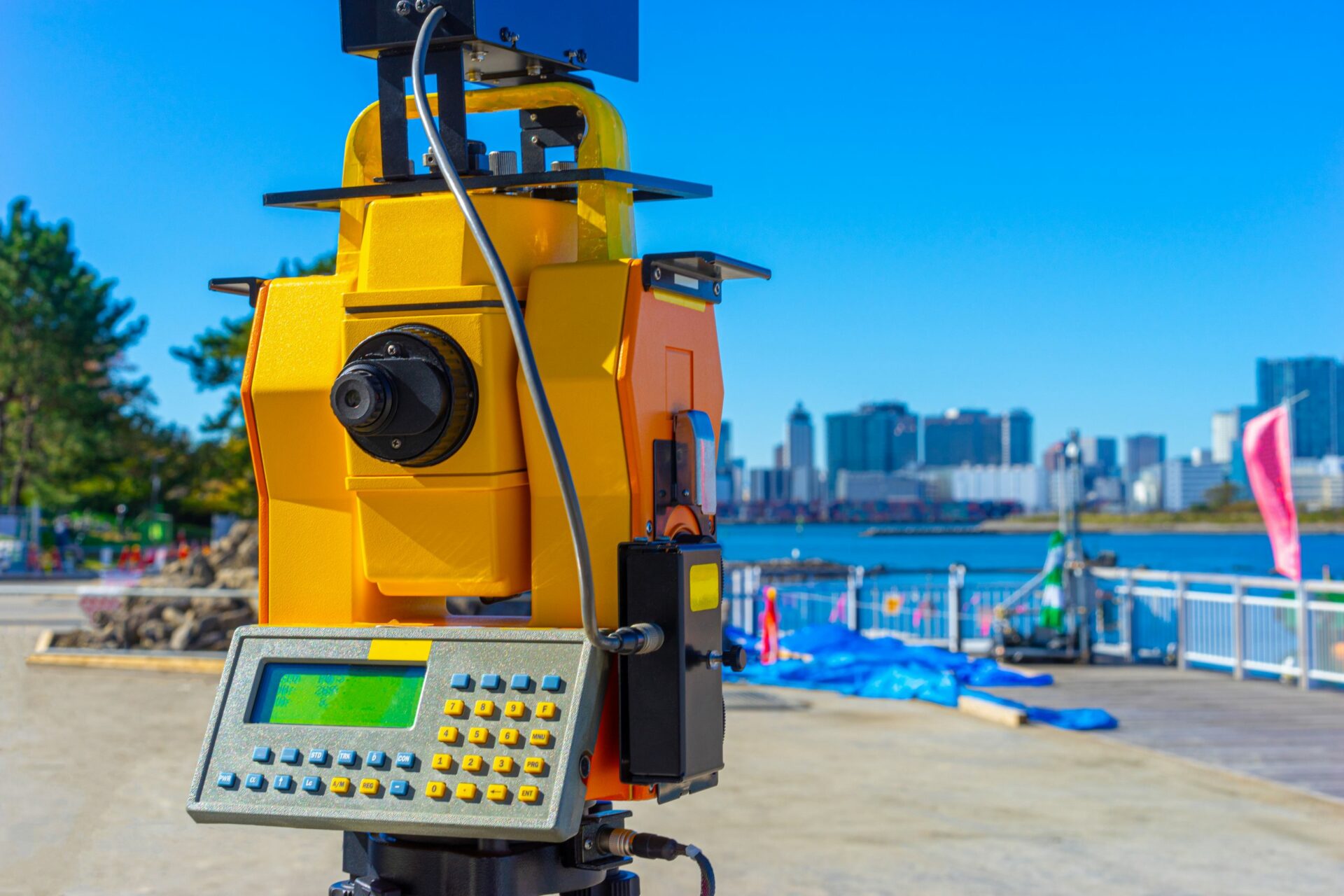 Total station used for survey next to water body